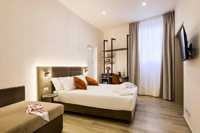 a hotel room with two beds and a window at Urban Guesthouse Monti in Rome