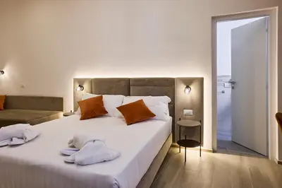 a bedroom with a large bed with towels on it at Urban Guesthouse Monti in Rome