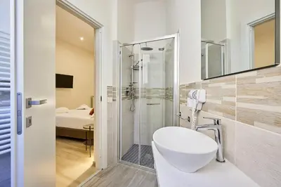 a bathroom with a white toilet and a shower at Urban Guesthouse Monti in Rome