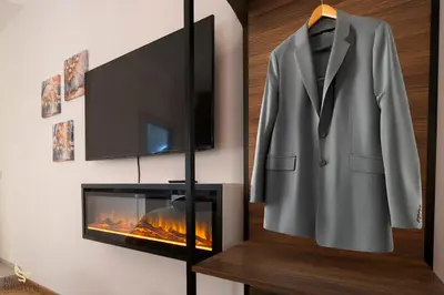 a suit on a mannequin next to a fireplace at MrBrown - Dimora Lucrezia al Vaticano in Rome