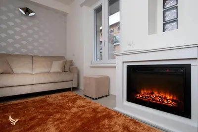 a living room with a couch and a fireplace at MrBrown - Dimora Lucrezia al Vaticano in Rome