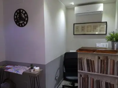 a room with a desk and a chair and a clock at NL Trastevere in Rome
