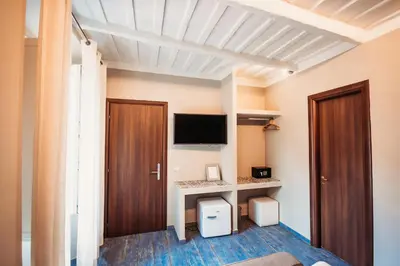 a room with a desk and a tv and a door at NL Trastevere in Rome