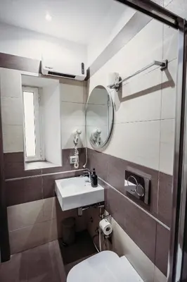 a bathroom with a sink and a mirror at NL Trastevere in Rome
