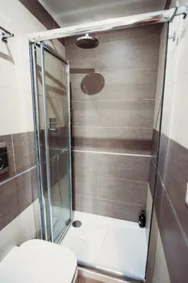 a bathroom with a glass shower with a toilet at NL Trastevere in Rome