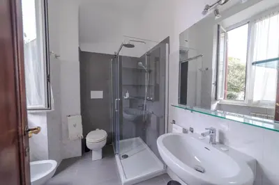 a bathroom with a sink and a toilet and a shower at Oasi Tiberina in Rome