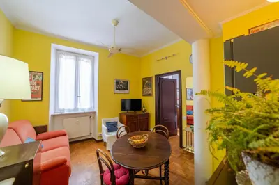 a living room with a table and a couch at Oasi Tiberina in Rome