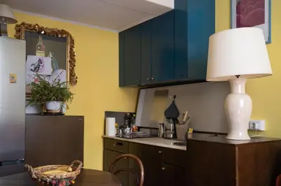 a kitchen with a table and a lamp on a counter at Oasi Tiberina in Rome