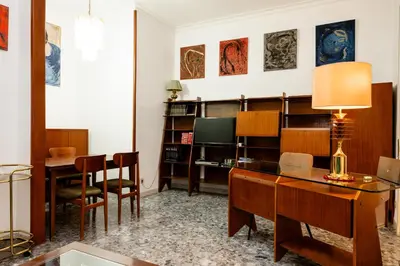 a bedroom with a bed and large windows at La casa dell'artista in Rome