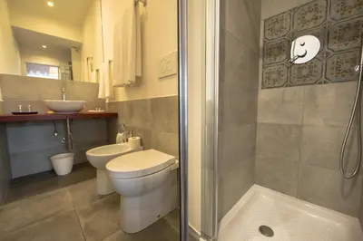 a bathroom with a shower and a toilet and a sink at B&B Roma 474 in Rome