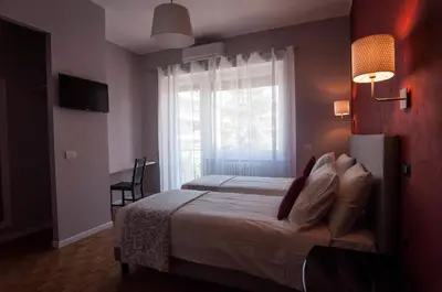 a bedroom with a large bed and a window at B&B Roma 474 in Rome