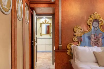 a bedroom with a bed and a painting on the wall at Casa dell'Opera LUXURY STAY in Rome