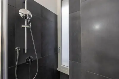 a shower with a shower head in a bathroom at Ottaviano Vatican Museums Stay 5 min from Metro in Rome