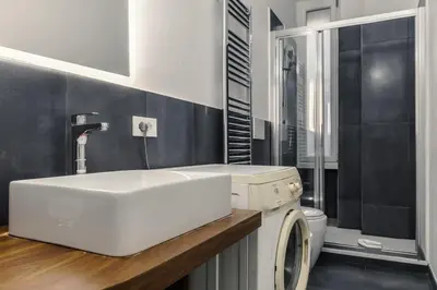 a bathroom with a sink and a washing machine at Ottaviano Vatican Museums Stay 5 min from Metro in Rome