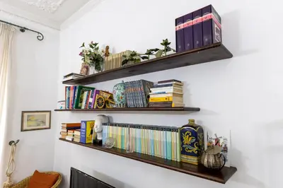 a bunch of books on shelves on a wall at Ottaviano Vatican Museums Stay 5 min from Metro in Rome