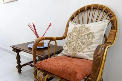 a chair with a pillow and a table at Ottaviano Vatican Museums Stay 5 min from Metro in Rome