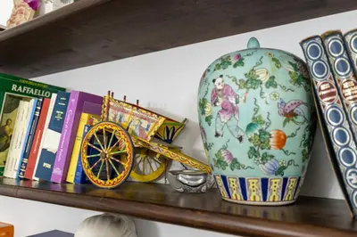 a shelf with books and a vase and a toy train at Ottaviano Vatican Museums Stay 5 min from Metro in Rome
