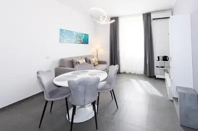 a living room with a table and chairs and a couch at Travel House in Rome