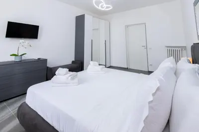 a bedroom with a white bed with white pillows at Travel House in Rome