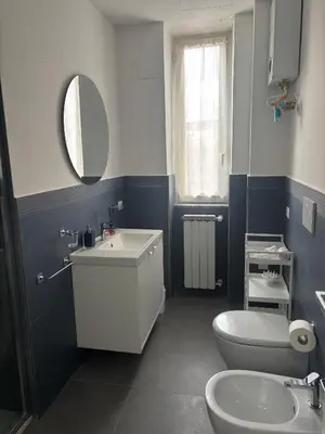 a bathroom with a sink and a toilet and a mirror at Travel House in Rome