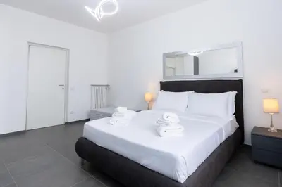 a bedroom with a large bed with two towels on it at Travel House in Rome