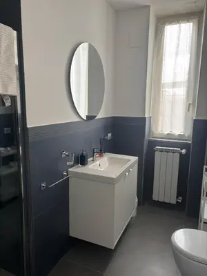a bathroom with a white sink and a mirror at Travel House in Rome