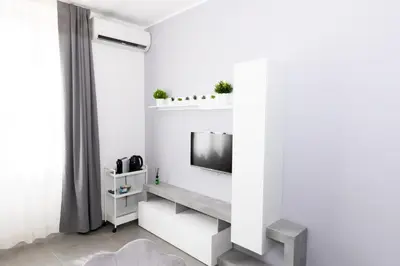 a living room with a tv on a white wall at Travel House in Rome