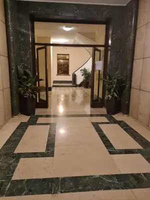 a hallway of a building with potted plants at Red Moon House - tra Policlinico e Piazza Bologna in Rome