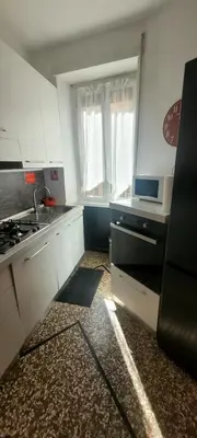 a small kitchen with white cabinets and a sink at Red Moon House - tra Policlinico e Piazza Bologna in Rome