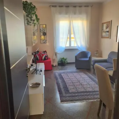 a living room with a couch and a table at Red Moon House - tra Policlinico e Piazza Bologna in Rome