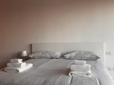 a bedroom with a bed with towels on it at Alberto's panoramic flat in Rome
