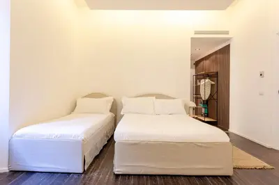 two beds sitting next to each other in a room at Cunabu Sardegna in Rome