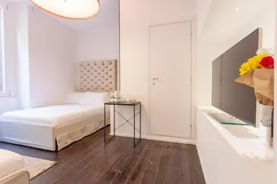 a bedroom with a bed and a table with a mirror at Cunabu Sardegna in Rome