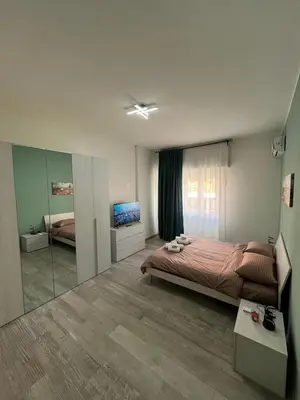 a bedroom with a bed and a mirror at RenMa Caffarella House in Rome