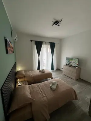 a bedroom with two beds and a window at RenMa Caffarella House in Rome