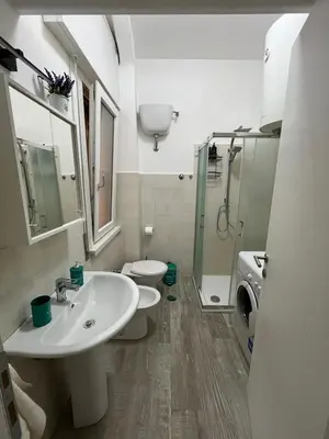 a bathroom with a sink and a toilet and a shower at RenMa Caffarella House in Rome