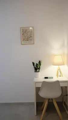 a white desk with a chair and a lamp at Augusto's House b&b in Rome