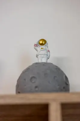 a figurine of an astronaut sitting on top of a rock at Macro House in Rome