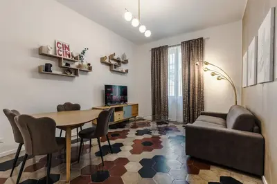 a living room with a table and a couch at Macro House in Rome
