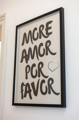 a sign that reads more anger pro favor hanging on a wall at Macro House in Rome