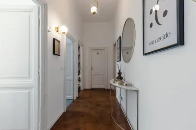 a hallway with white walls and a tile floor at Macro House in Rome