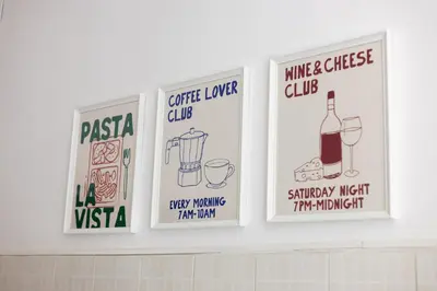 four signs on a wall above a kitchen counter at Macro House in Rome