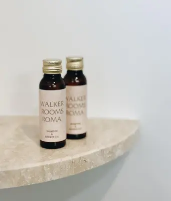 two jars of honey sitting on a marble shelf at Belle Epoque in Rome