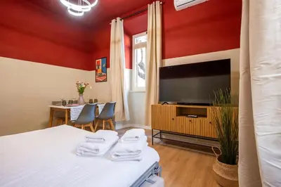 a guest room with a bed and a tv at Urban Oasis Metro B Piramide - 2 subway stations from Colosseo in Rome