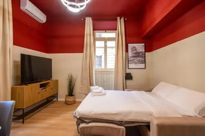 a bedroom with a bed and a flat screen tv at Urban Oasis Metro B Piramide - 2 subway stations from Colosseo in Rome
