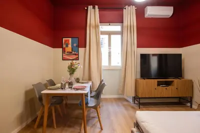a dining room with a table and a tv at Urban Oasis Metro B Piramide - 2 subway stations from Colosseo in Rome