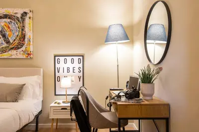a bedroom with a desk with a bed and a mirror at Urban Oasis Metro B Piramide - 2 subway stations from Colosseo in Rome