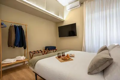 a bedroom with a bed with a tray of food on it at Urban Oasis Metro B Piramide - 2 subway stations from Colosseo in Rome