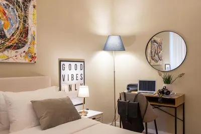 a bedroom with a bed and a desk with a laptop at Urban Oasis Metro B Piramide - 2 subway stations from Colosseo in Rome