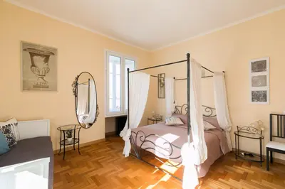 a bedroom with a bed with a canopy at Home Domus Giulio Cesare - Vatican Museum in Rome